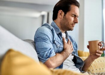 Um homem segura sua xícara com dor no coração