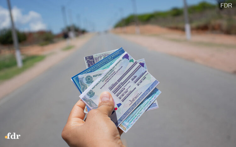 Uma mão segura o documento da CNH que pode ser suspensa após decisão do STF
