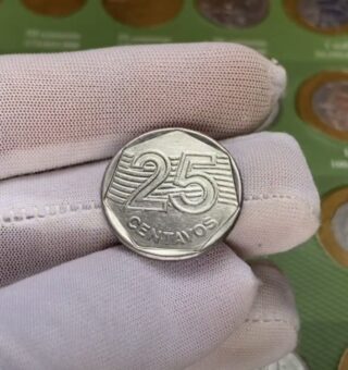 Uma moeda de 25 centavos na mão de uma pessoa (com luva branca)