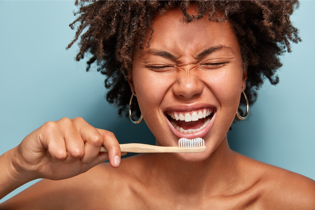 Mulher escovando com a pasta de dente proibida