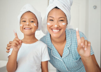 Skincare, grooming and portrait of mother and daughter smile, happy with hygiene treatment and face cream while bonding in bathroom. Cleaning, beauty and facial with excited girl and parent selfcare.