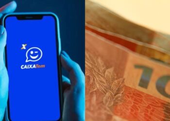 Caixa ao lado de notas de reais
